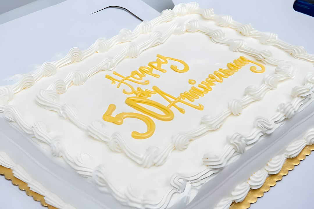 Square white cake with gold anniversary lettering