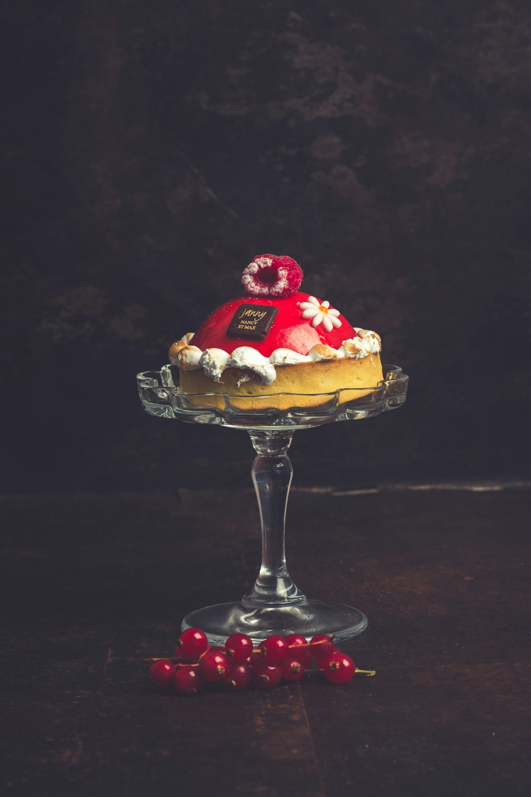 A single mini cake on a glass stand
