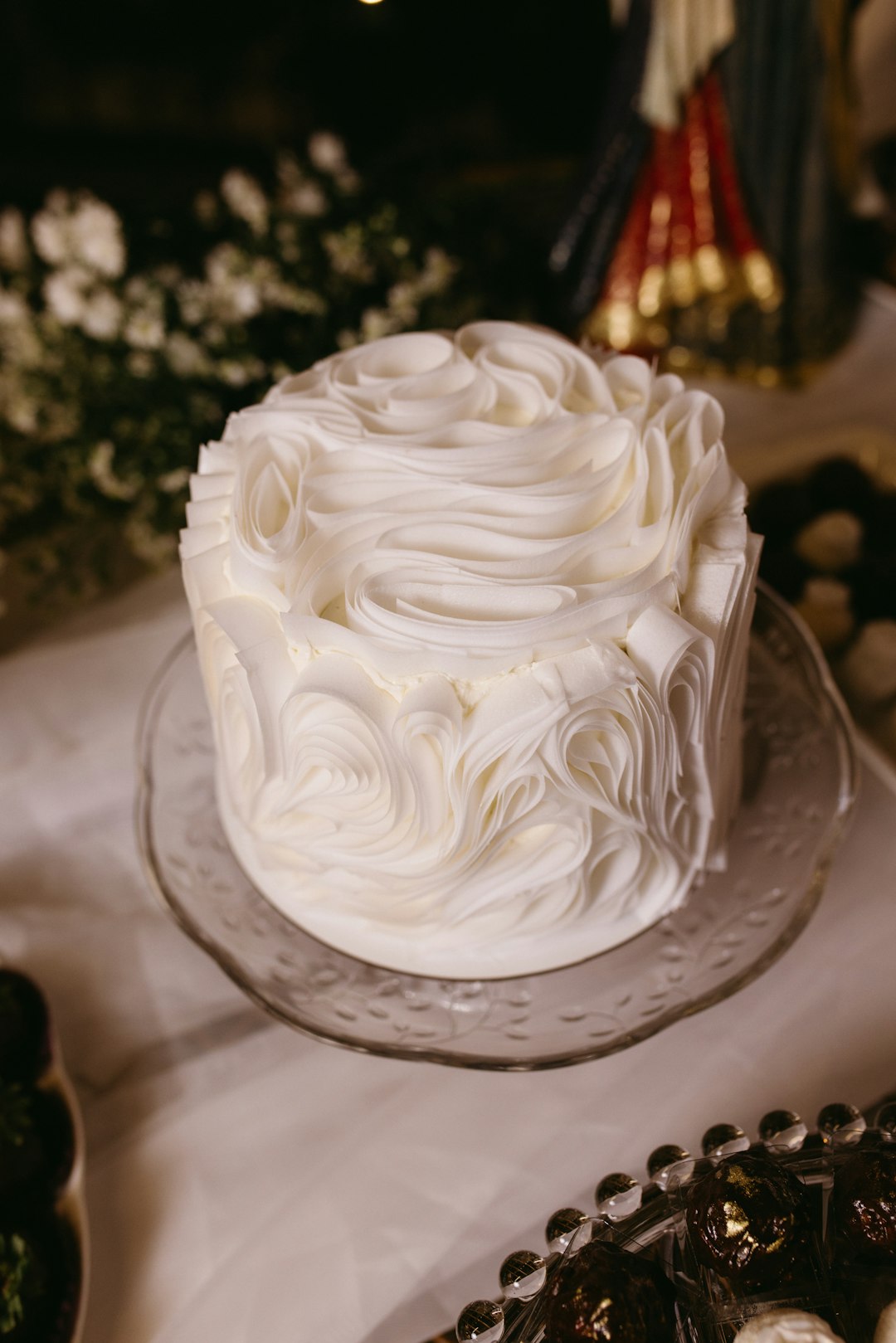 A small white cake finished by hand